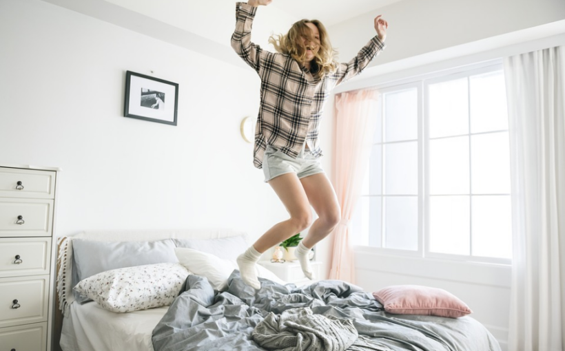 a woman jumping on the bed