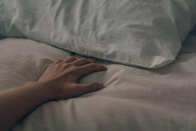 hand on bed